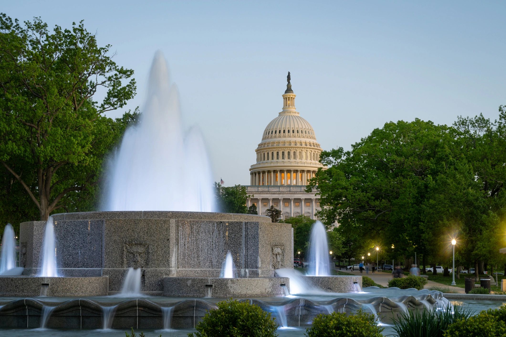 U.S. Capitol and fountain at dusk in Washington, DC